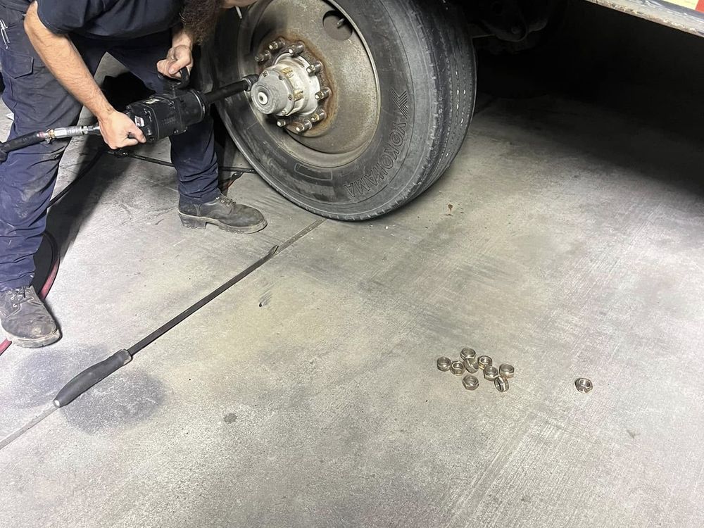 Technician removing a wheel for brake work