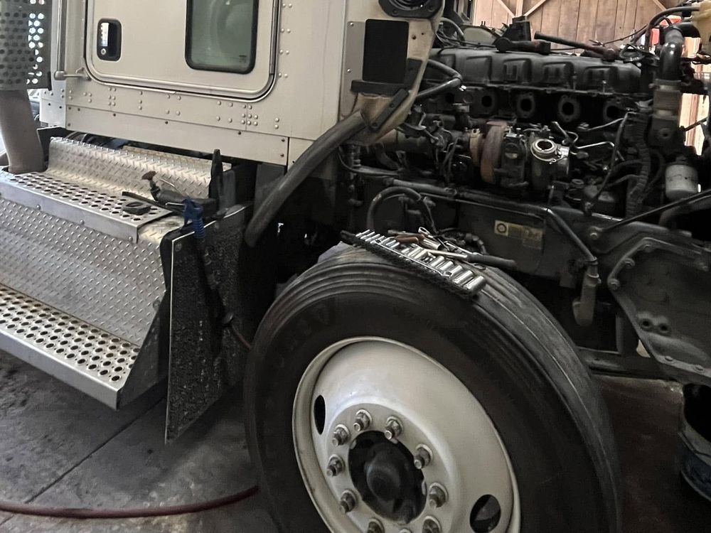 Work truck with engine exposed during an in-shop repair